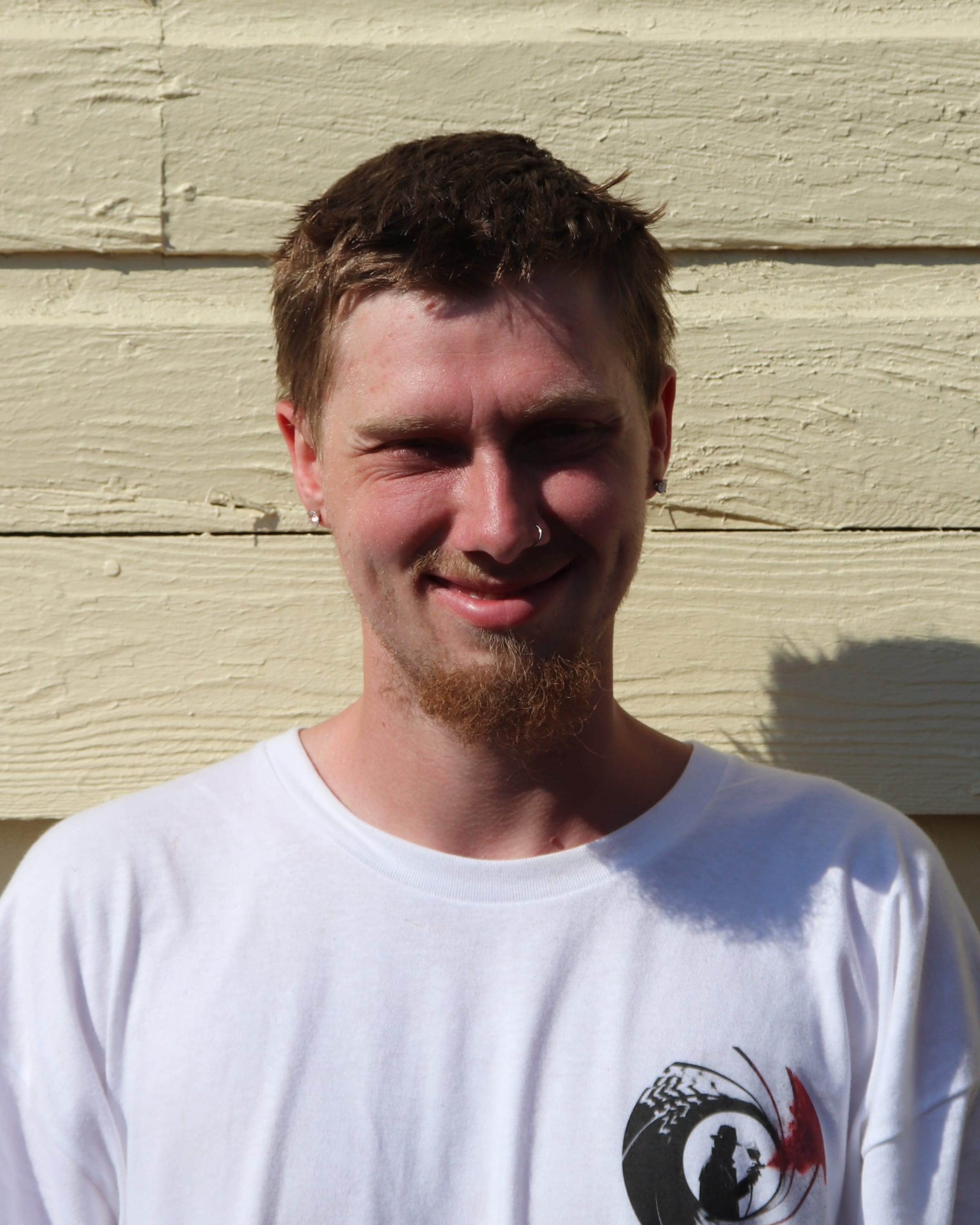 Portrait of a Paint Gunners crew member in a branded shirt