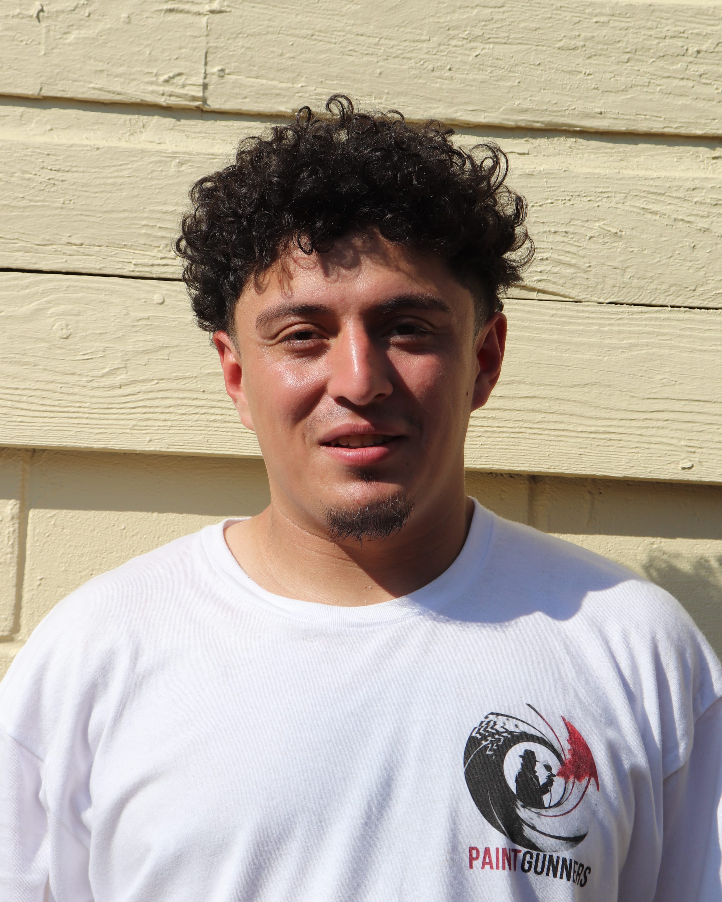 Portrait of a young Paint Gunners crew member in a branded shirt